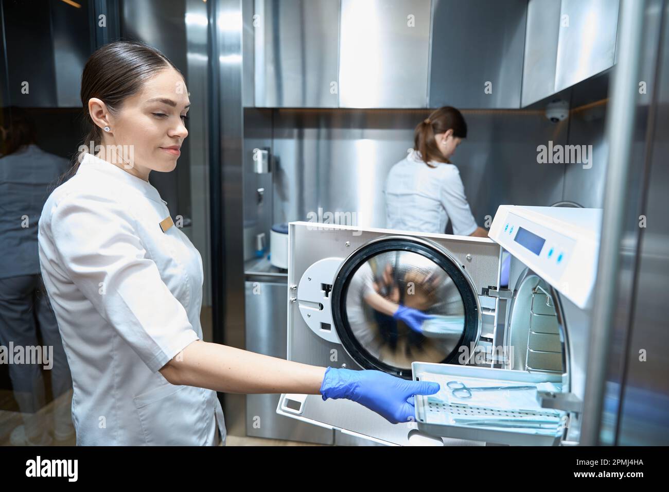 Young woman is sterilizing medical instruments in an autoclave Stock ...
