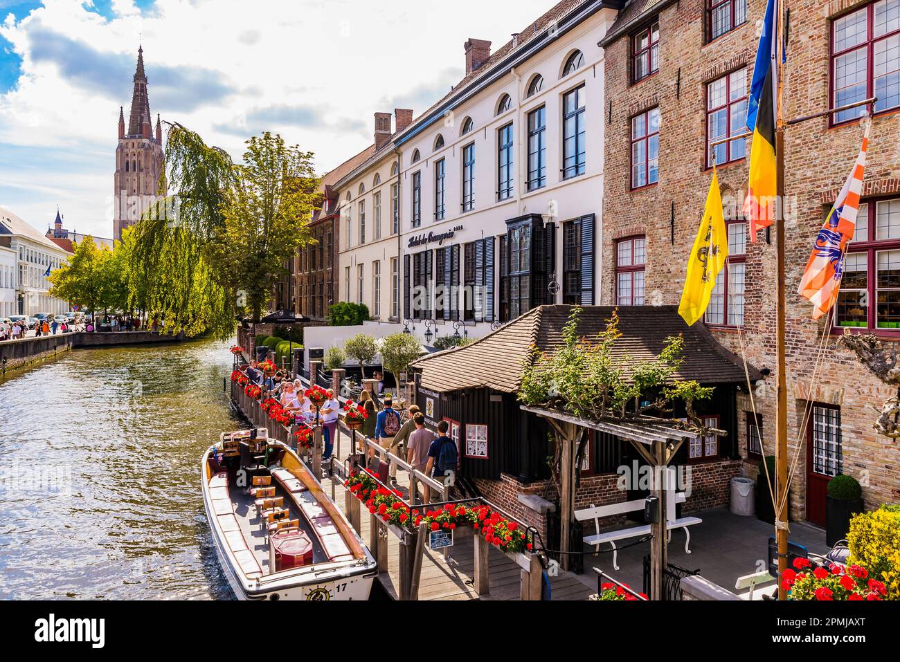 Bruges River Cruises next to Sint-Jan Nepomucenus bridge. Bruges, West Flanders, Belgium, Europe Stock Photo