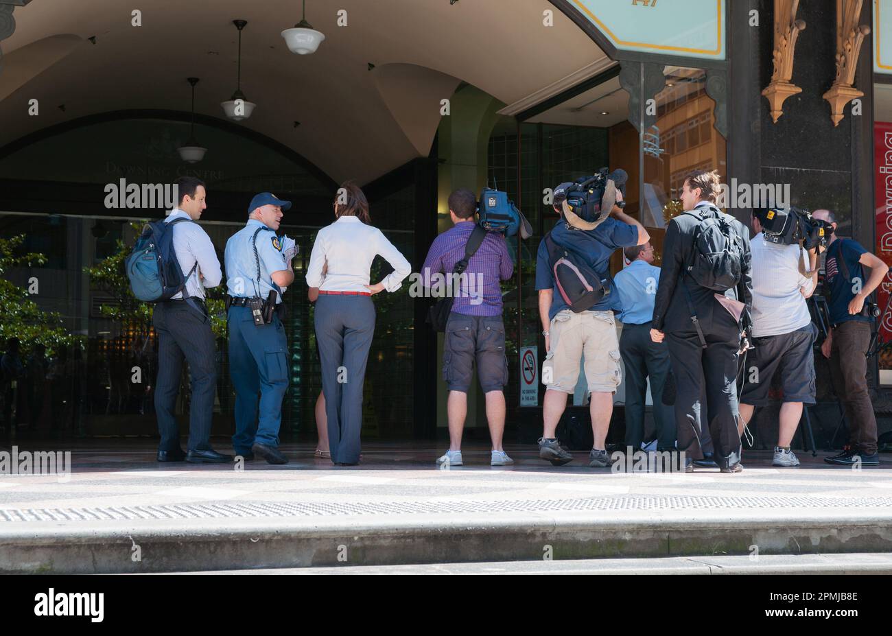 Sydney Australia - January 26 2011; Cameramen,journalists and police waiting for trial personnel on top step outside courthouse. Stock Photo