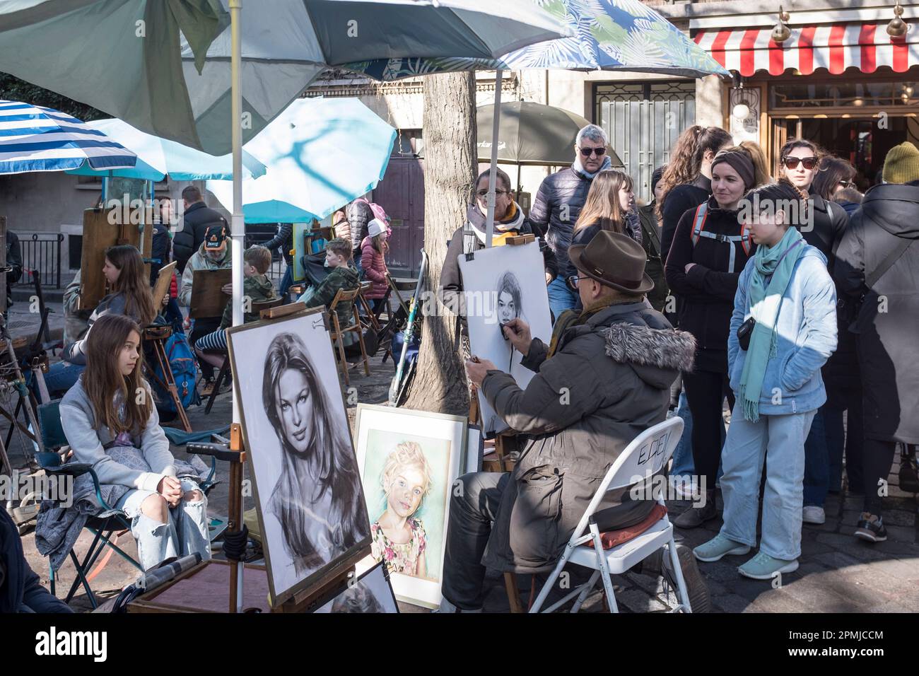 Portraits artists at work in the Spring sunshine, Place du Tertre, in Montmartre, in Paris, France Stock Photo