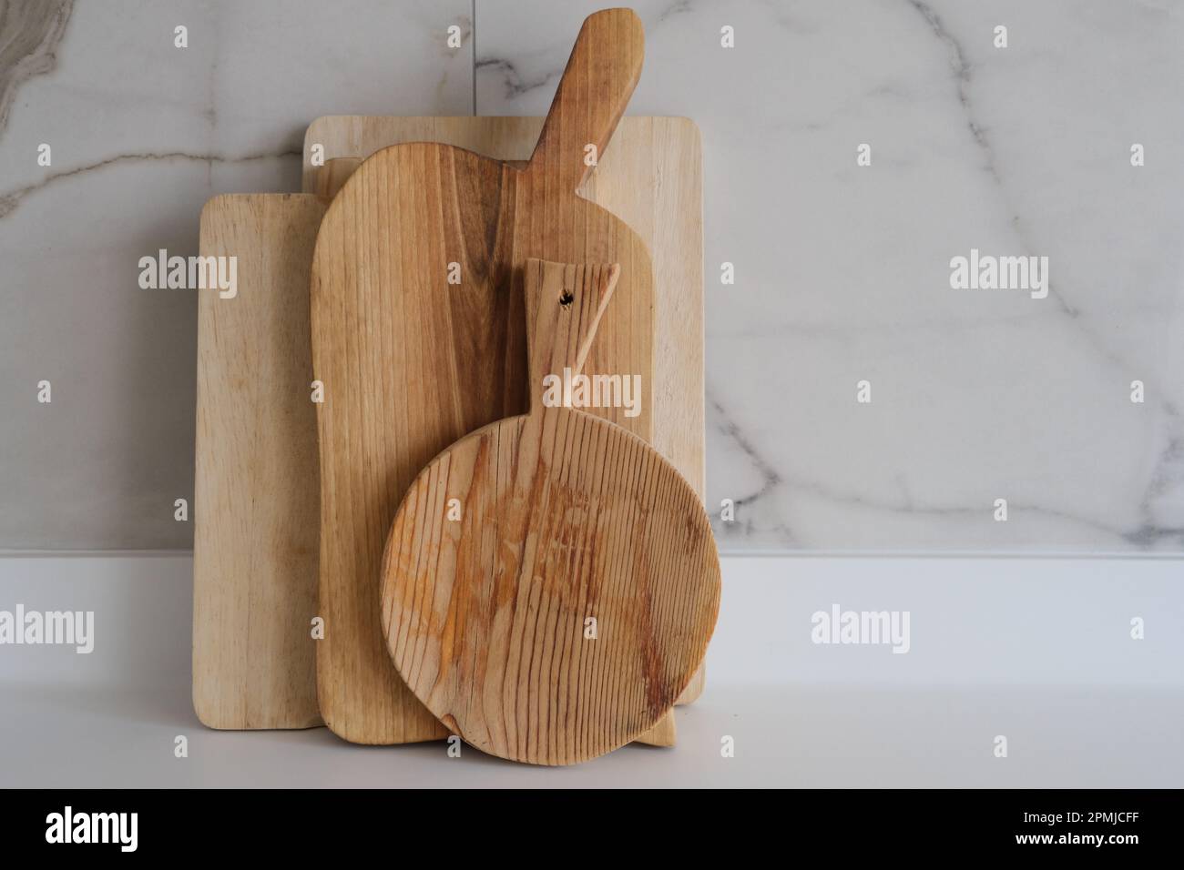 Wooden chopping boards on kitchen countertops. Set of wood cutting