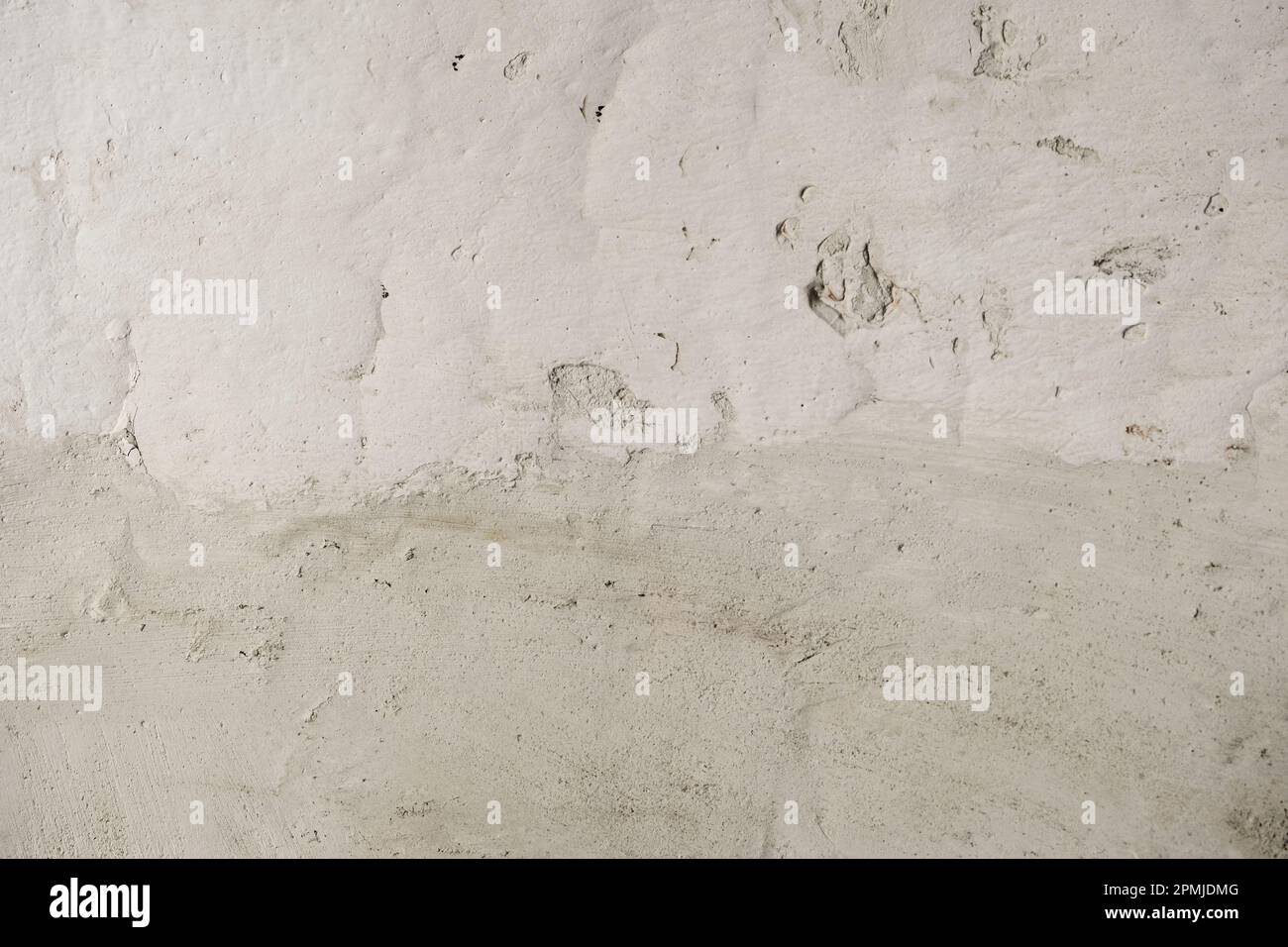 Detail of cement render plaster coating on old white lime washed wall