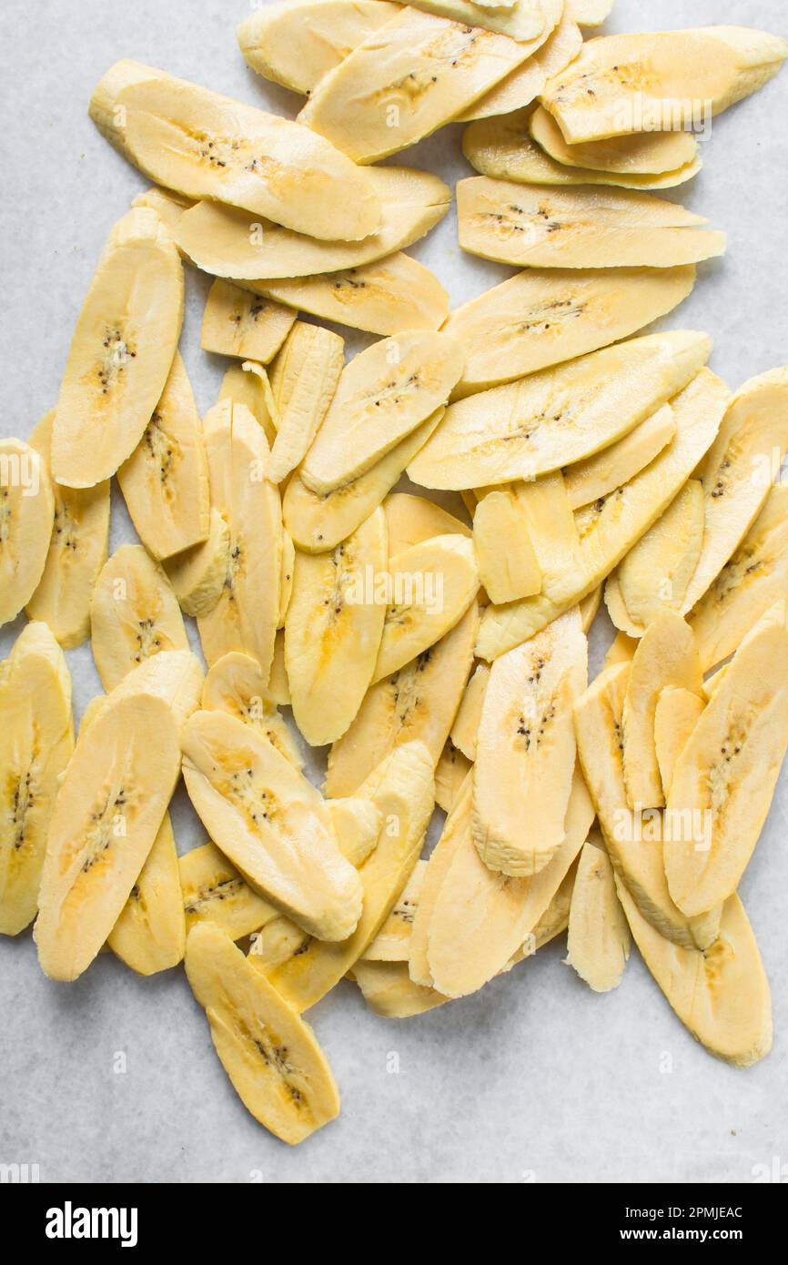 Top view of slices of ripe plantains , slices of yellow plantains for frying, process for making fried plantain Stock Photo