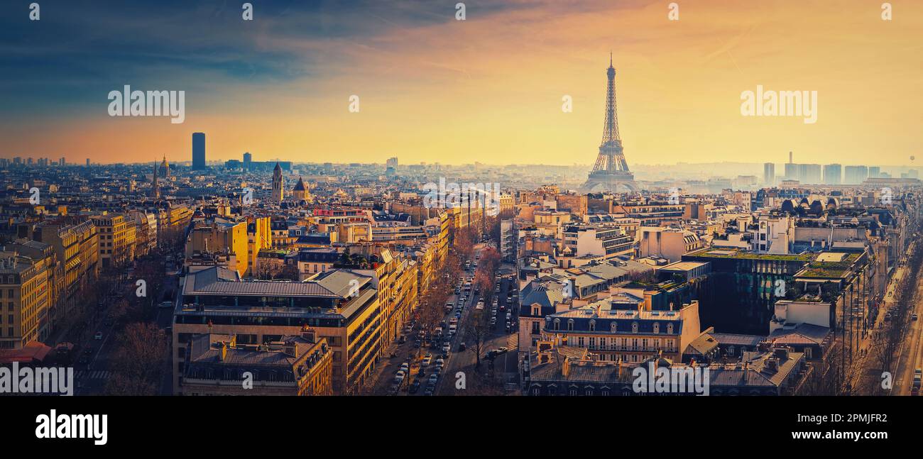 Sightseeing Paris panorama with view to the Eiffel Tower, France. Beautiful parisian cityscape sunset scene. Romantic view over rooftops of historic b Stock Photo