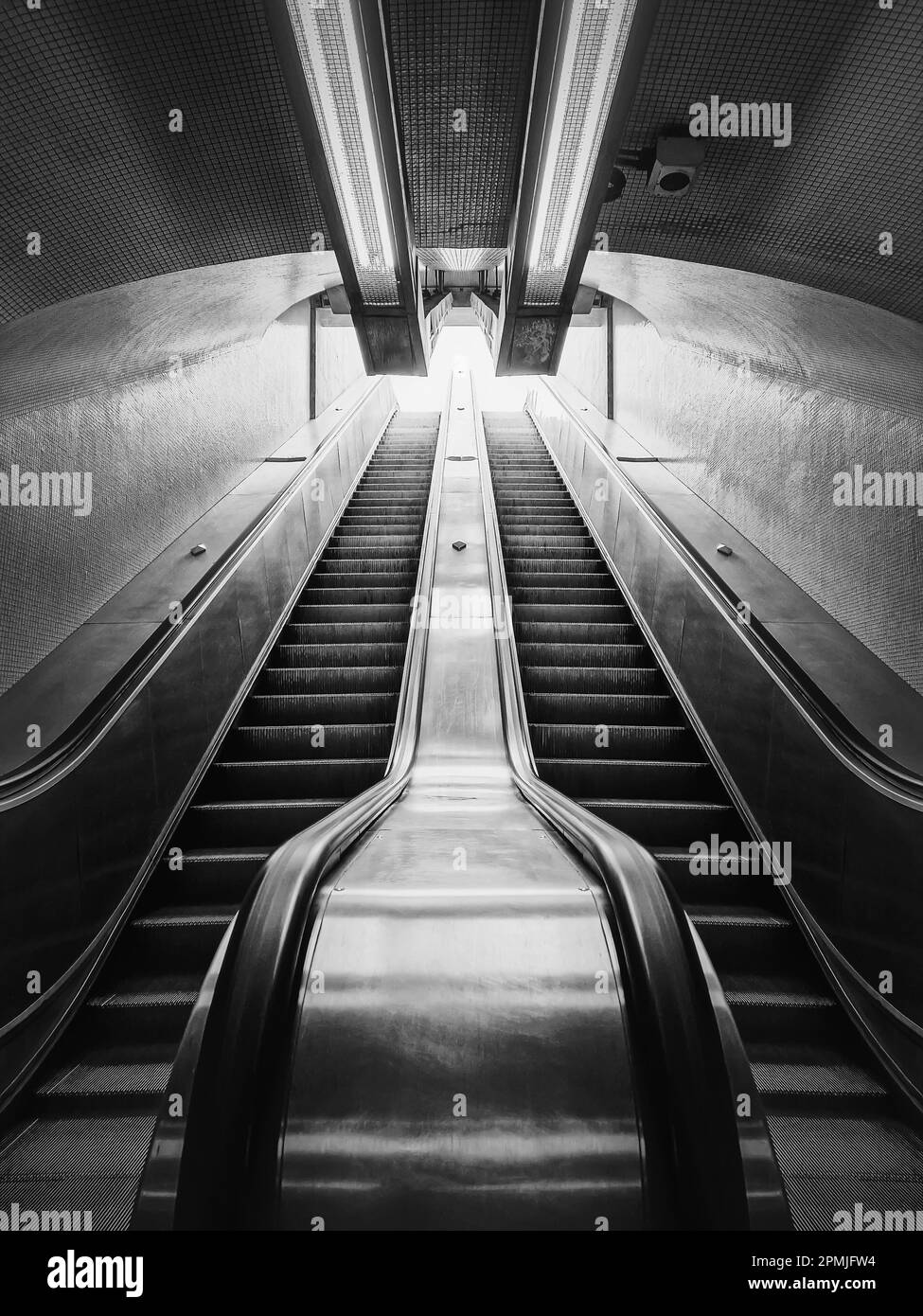 Subway escalator black and white architectural details. Symmetrical underground moving staircase Stock Photo