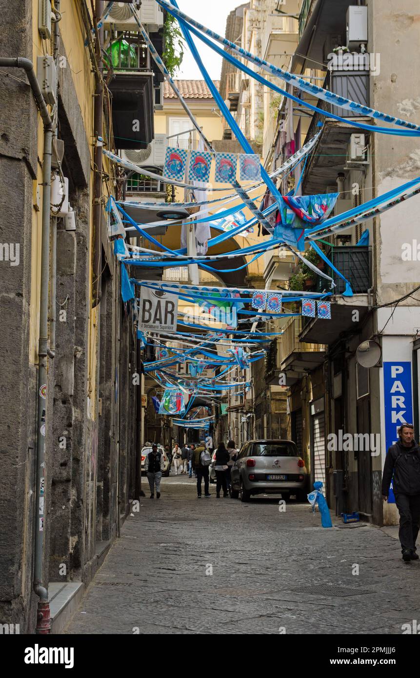 Naples, Italy - April 2, 2023: Flags, bunting and streamers stretched across the Via San Giuseppe dei Ruffi in the Centro Storico district in the cent Stock Photo