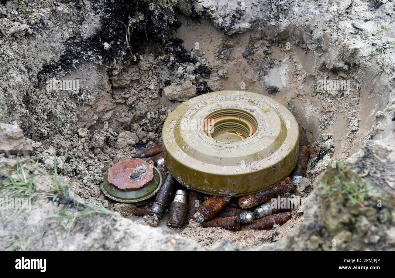 KYIV, UKRAINE - APRIL 13, 2023 - TM-62M anti-tank mine and VOG-25 ammunition for under-barrel grenade launchers discovered in the de-occupied territory of Kyiv Region, capital of Ukraine. Stock Photo