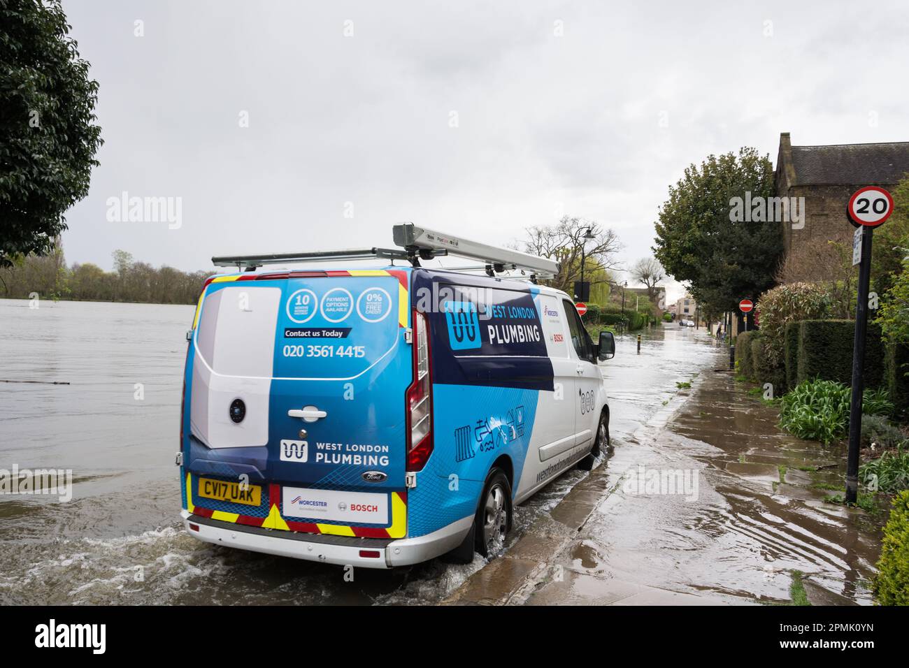 A plumbers van battling through high tide flooding on Chiswick Mall in Chiswick, south west London, England, UK Stock Photo