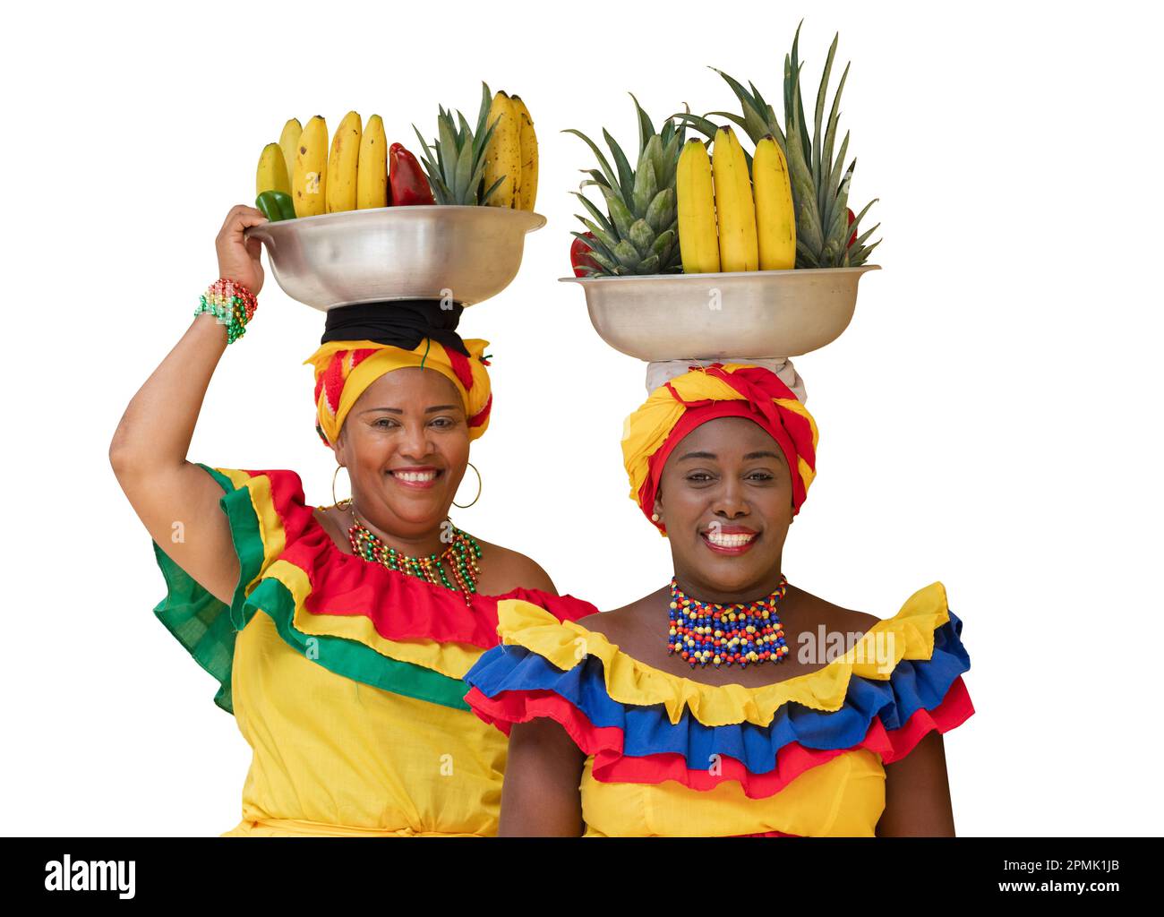 Happy fresh fruit street vendors aka Palenqueras, isolated on white background. Afro-Colombian woman in traditional costumes, Cartagena, Colombia. Stock Photo