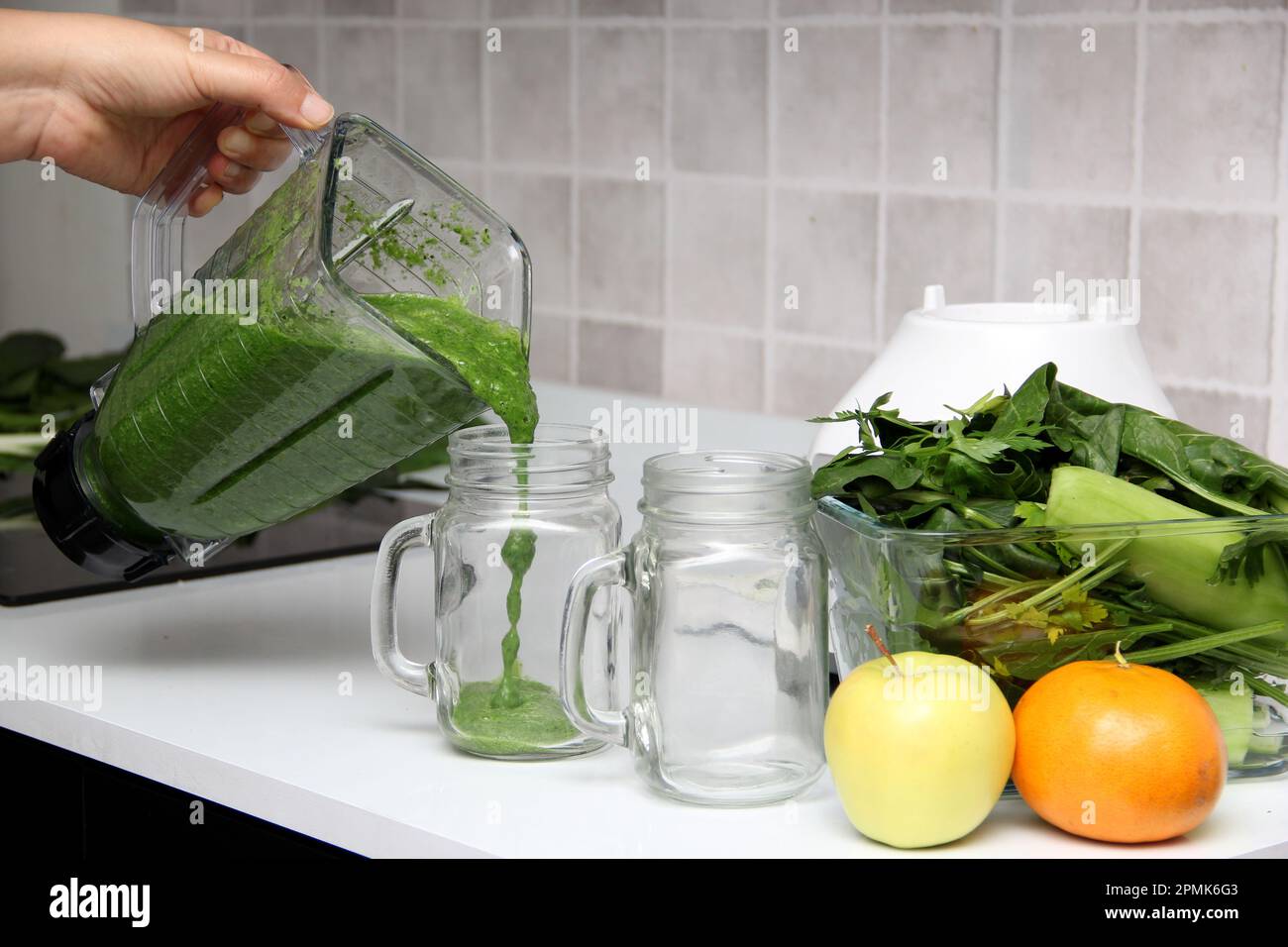 Serve green juice in mason jar just made in kitchen blender with