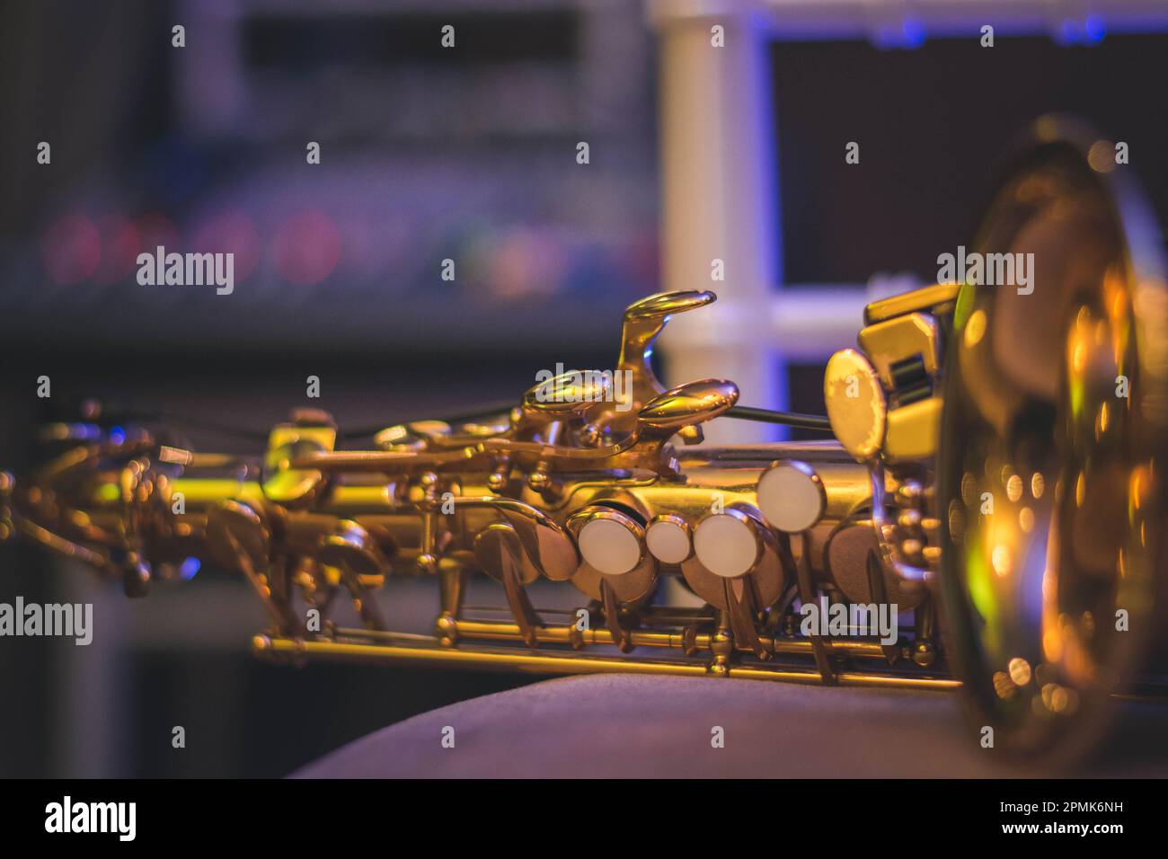A closeup shot of a golden saxophone, displaying the instrument's keys