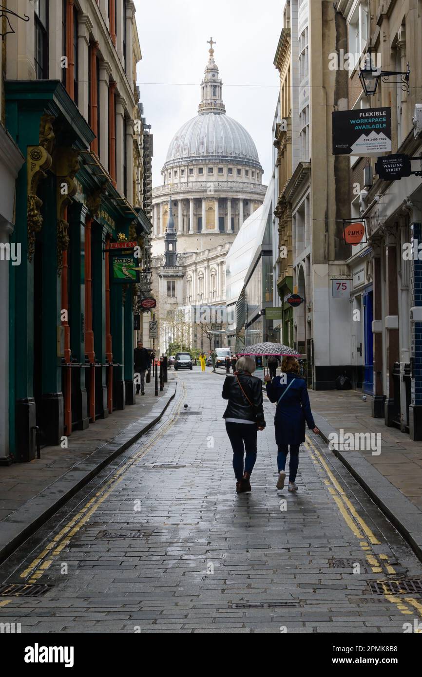 London, UK March 18, 2023; Two people with an umbrella walking in an