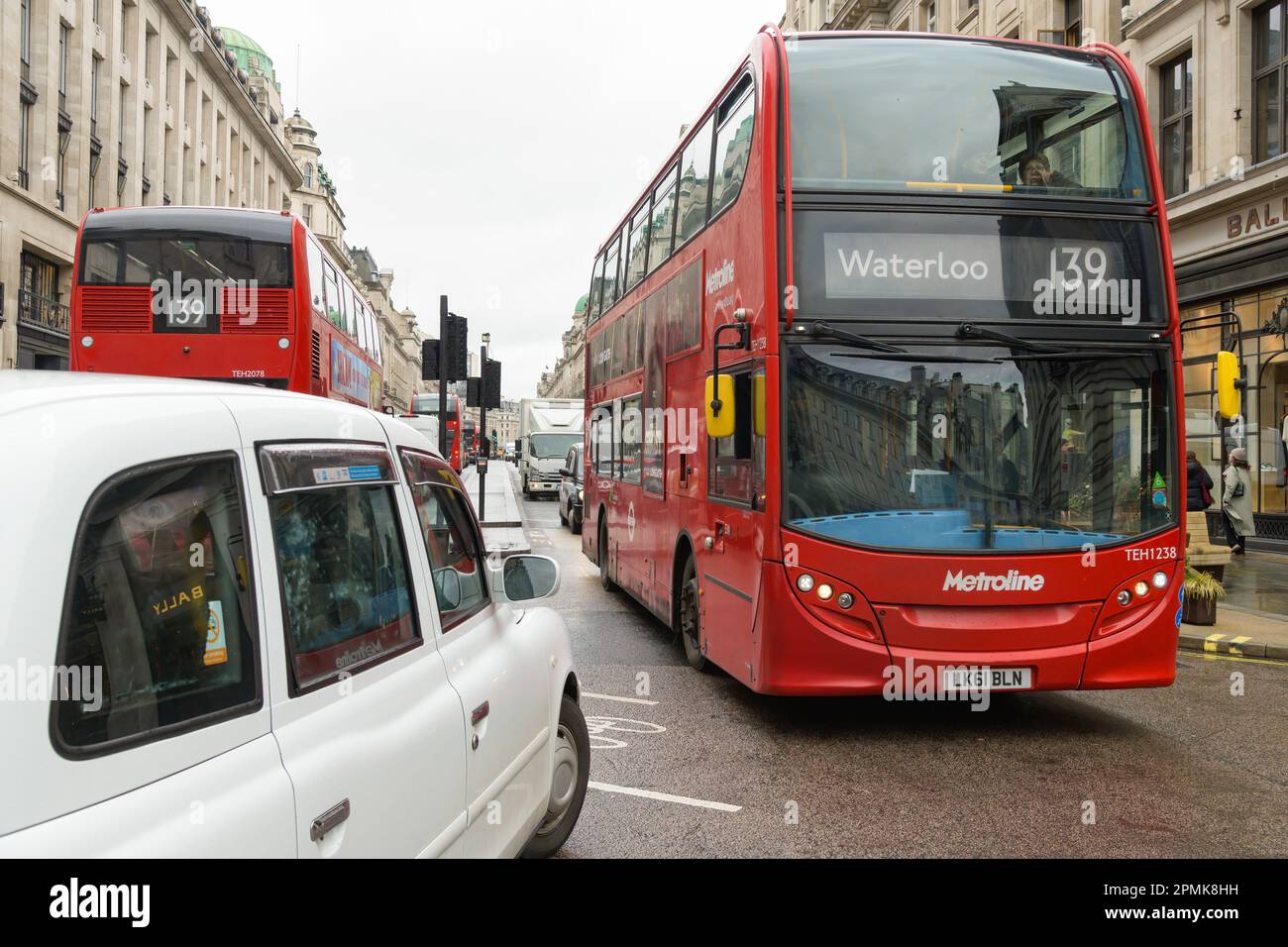 London, UK -March 17, 2023; Busy traffic on Regent Street with red double decker bus and white taxi Stock Photo