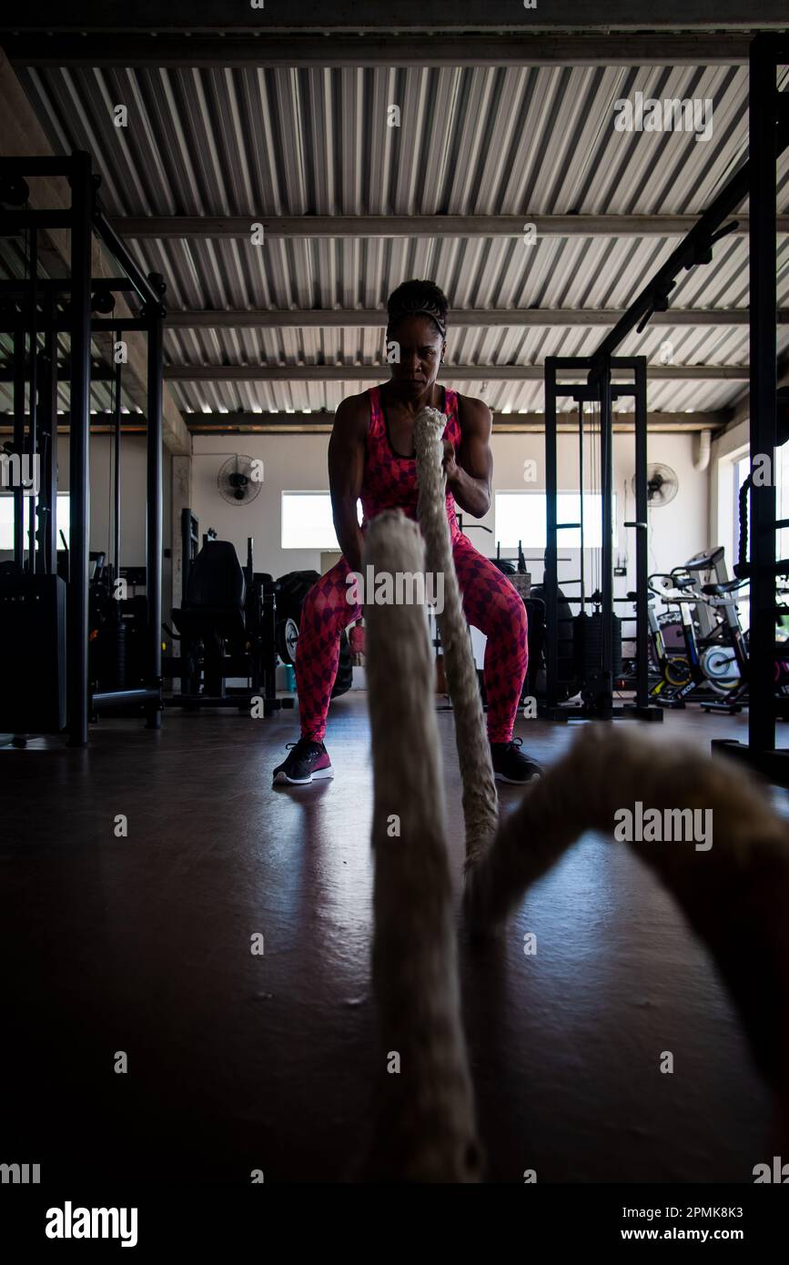 Woman doing training with naval rope. Abdominal strengthening and ...