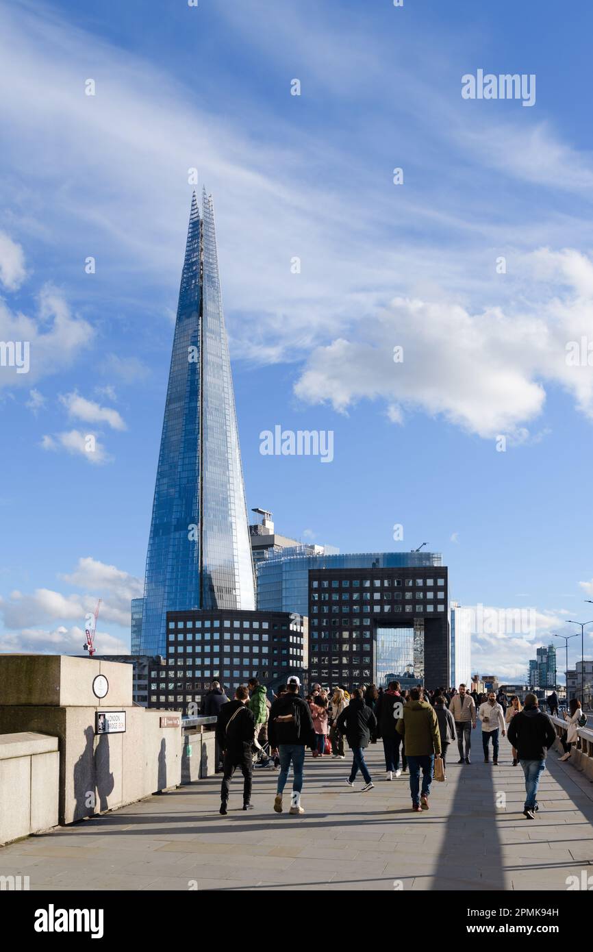London, UK -March 18, 2023; The Shard skyscraper rises above pedestrians on London Bridge Stock Photo