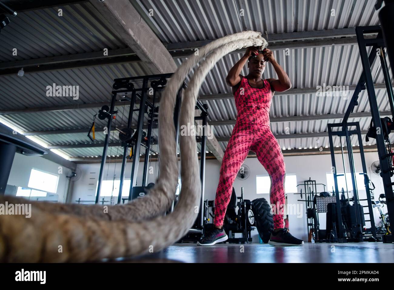 Woman doing training with naval rope. Abdominal strengthening and ...