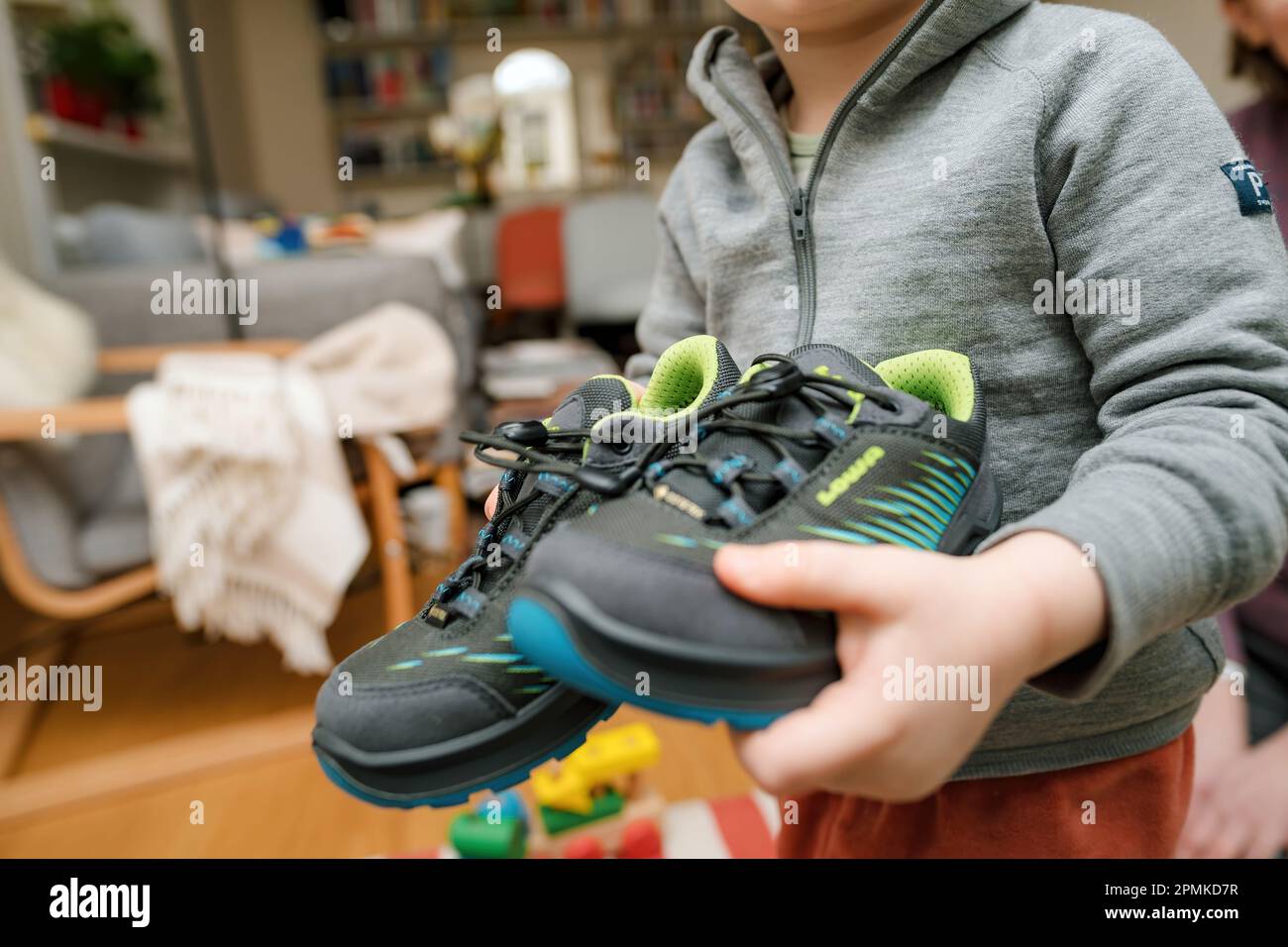 Frankfurt, Germany - Mar 12, 2023: A child showing modern, stylish Lowa  boots with vibrant blue and green design. Waterproof and insulated for  warmth in cold winter conditions Stock Photo - Alamy