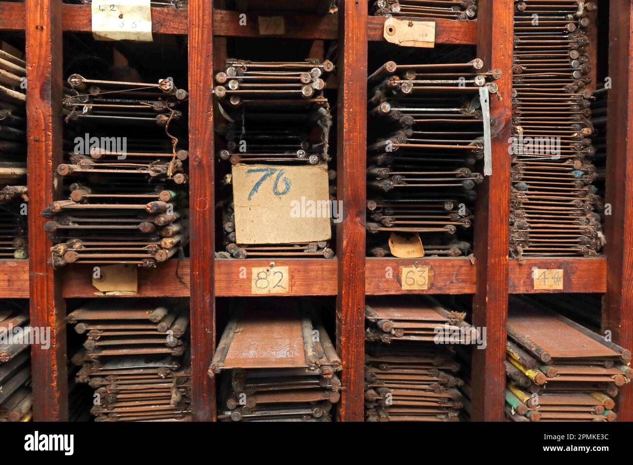 Weaving loom reeds of different lengths, stored in shelves, Cotton weaving mill, Burnley, Lancashire, England, UK, Stock Photo