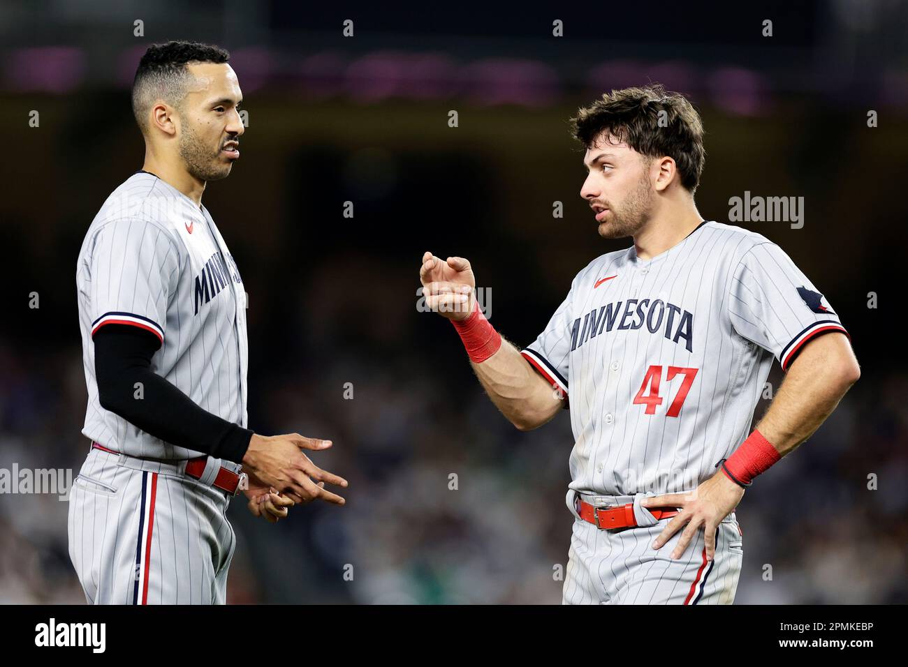 Minnesota Twins' Edouard Julien (47) talks to Carlos Correa