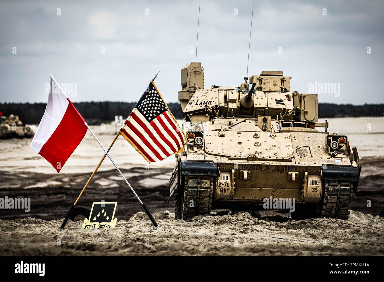 U.S. Soldiers assigned to the 2nd Battalion, 70th Armor Regiment, 2nd Armored Brigade Combat Team, 1st Infantry Division supporting the 4th Infantry Division, alongside Polish soldiers assigned to the 14th Artillery Battalion, 21st Brigade, 18th Mechanized Division participate in a live fire demonstration and static display for the Minister of National Defense of the Republic of Poland, Mariusz Blaszczak at Nowa Deba, Poland, April 12, 2023. The 4th Infantry Division's mission in Europe is to engage in multinational training and exercises across the continent in order to build readiness, incre Stock Photo