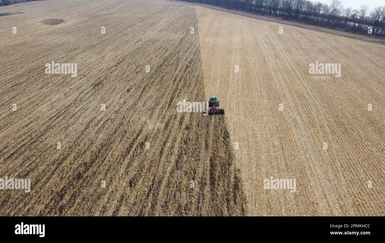 Drone flying after green tractor hi-res stock photography and images ...
