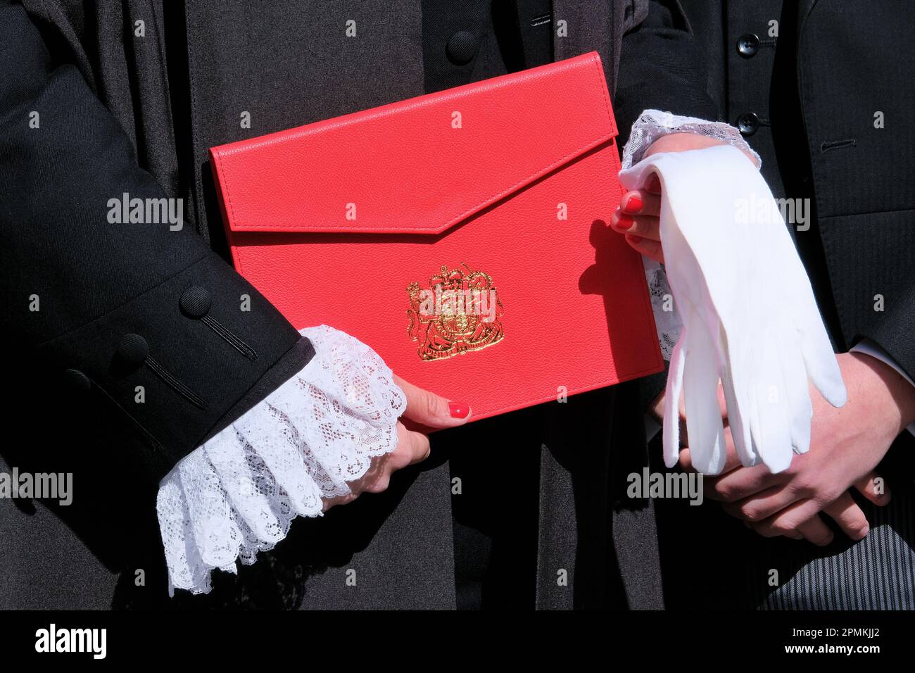 London, UK. A newly appointed legal member of the King's Counsel (KC) poses with letters of patent and white gloves on 'Silks Day' Stock Photo