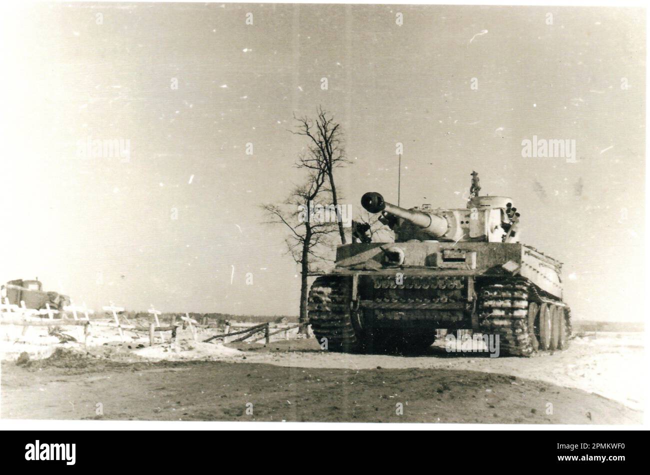 World War Two B&W photo German Tiger Tank advances passed a Grave Site on the Russian Front during the Winter 1943/44 Stock Photo
