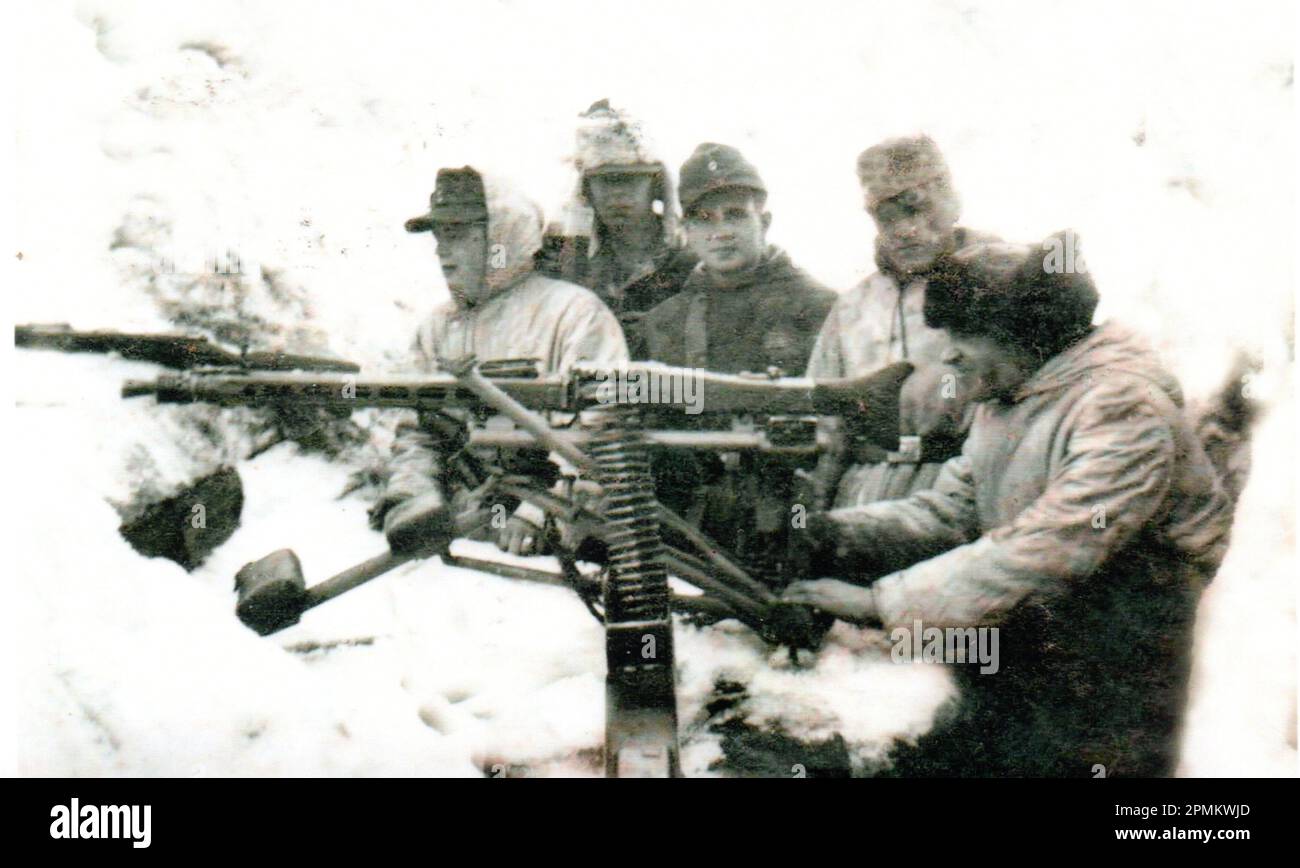 World War Two B&W photo German Soldiers in Camo Winter Parkas with a Heavy Mounted MG42 in Defensive position during the Winter of 1944/45 on the Eastern Front Stock Photo