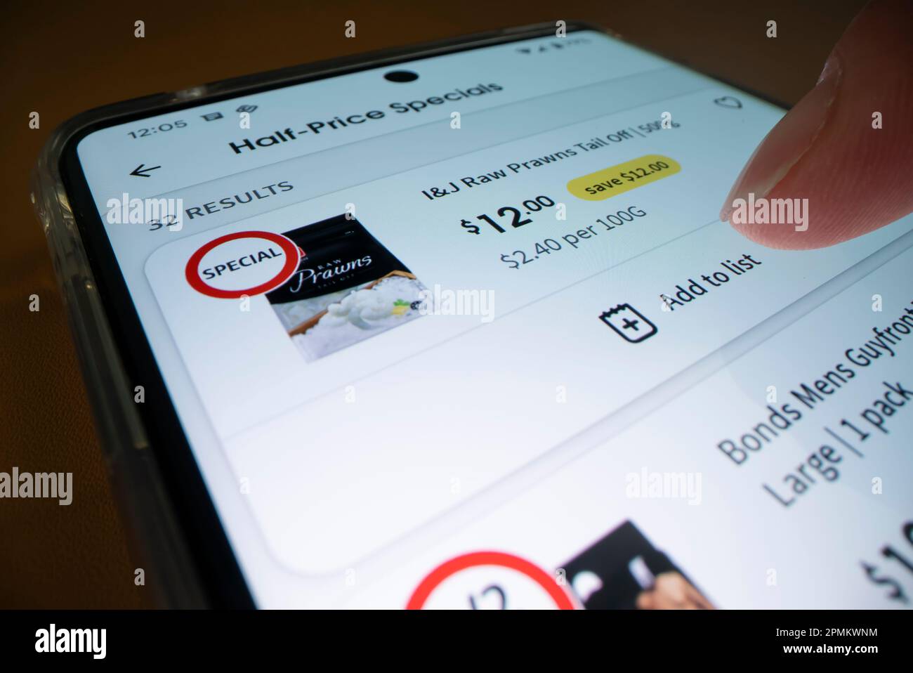 Melbourne, Australia - Dec 5, 2022: Online grocery shopping using smartphone app, shot with macro probe lens Stock Photo