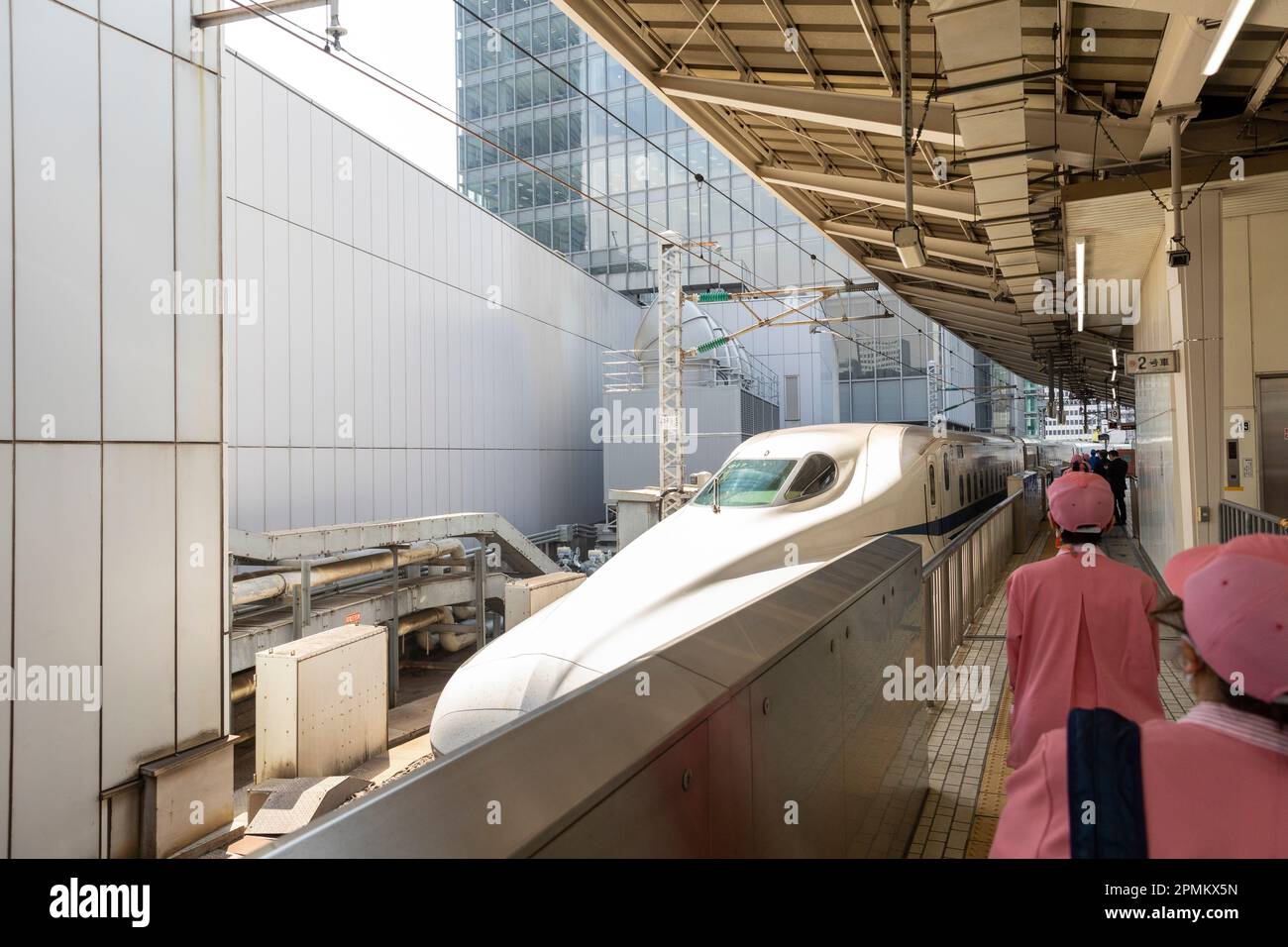 April 2023 Tokyo rail station cleaners wait to board the bullet train Shinkansen to adjust seats to direction of travel and clean the train,Japan Stock Photo