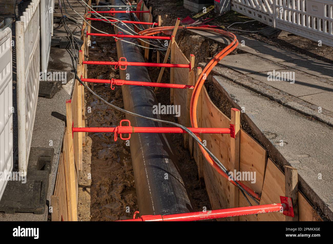 a district heating pipe buried in a street, a construction site in Frederikssund, Denmark, April 13, 2023 Stock Photo