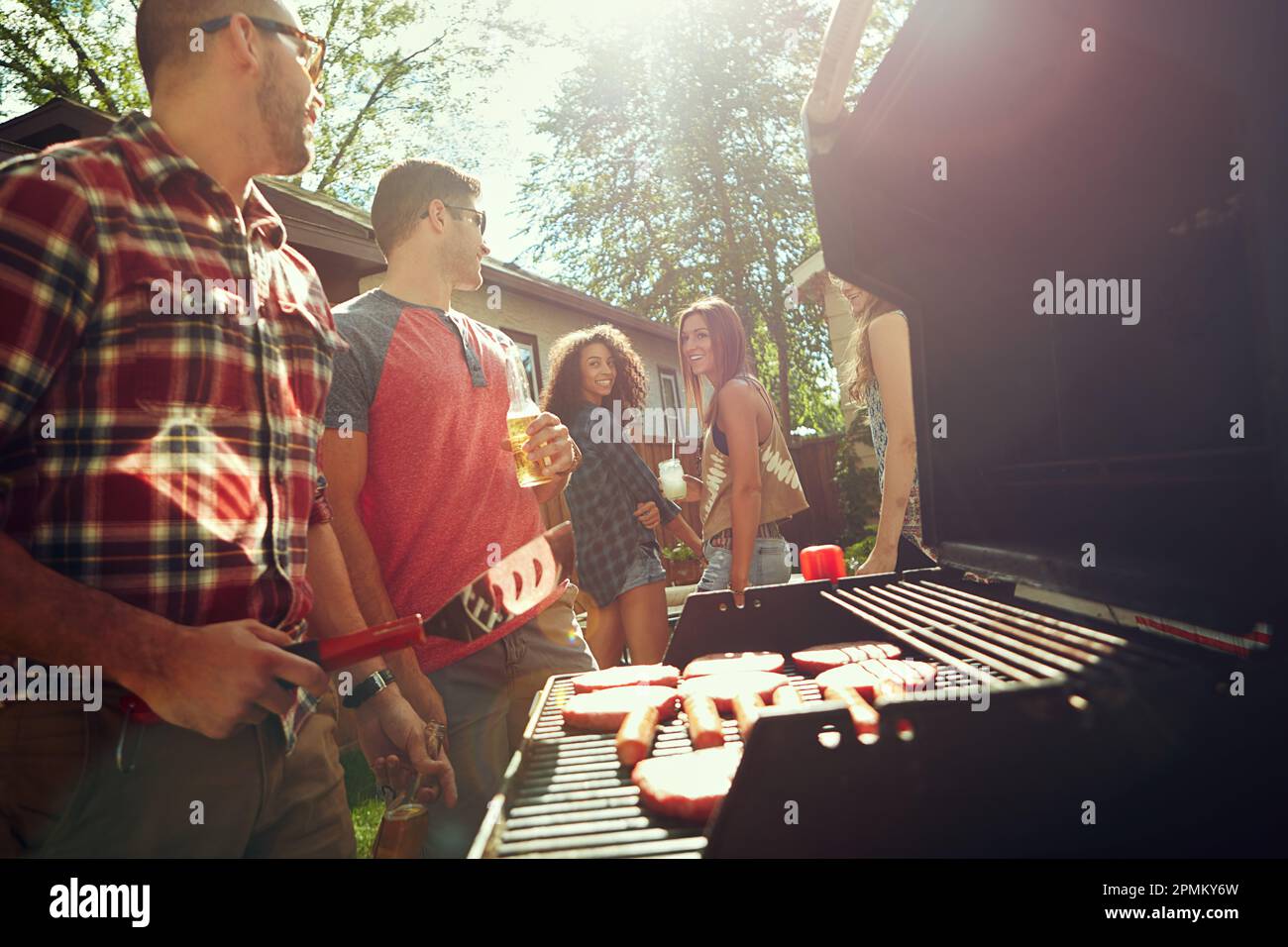 Weekend vibes with good friends. a group of friends having a barbecue ...
