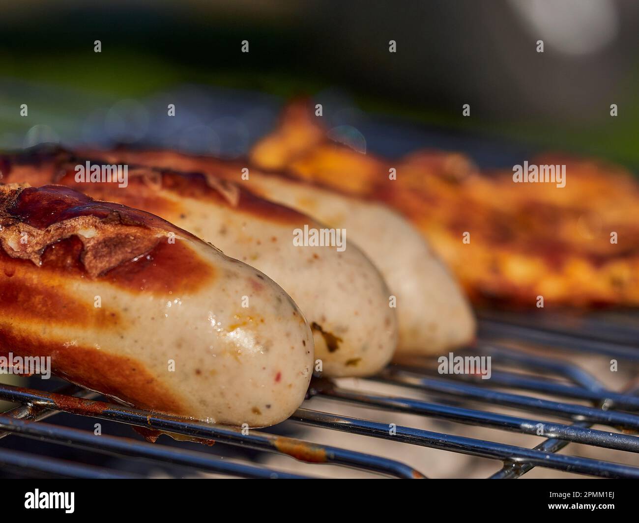 german bratwurst pork sausage cooking on a barbecue grill over open ...
