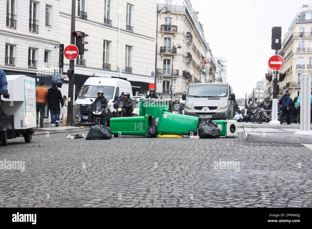 Paris, France. 13th Apr, 2023. Garbage cans placed in the middle of the road by high school students from Lycee Colbert. At the call of the inter-union, a twelfth day of mobilization against the pension reform project is being held this thursday in Paris from the Place of the Opera, on April 13, 2023 in Paris. Photo by Christophe Michel/ABACAPRESS.COM Credit: Abaca Press/Alamy Live News Stock Photo