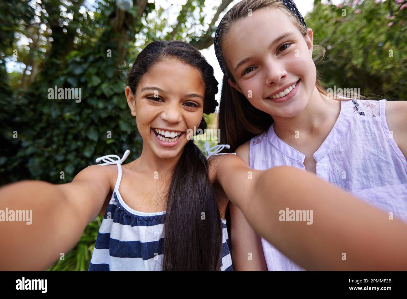 Good times are even better when shared with a friend. two young girl friends  taking a selfie together outside Stock Photo - Alamy