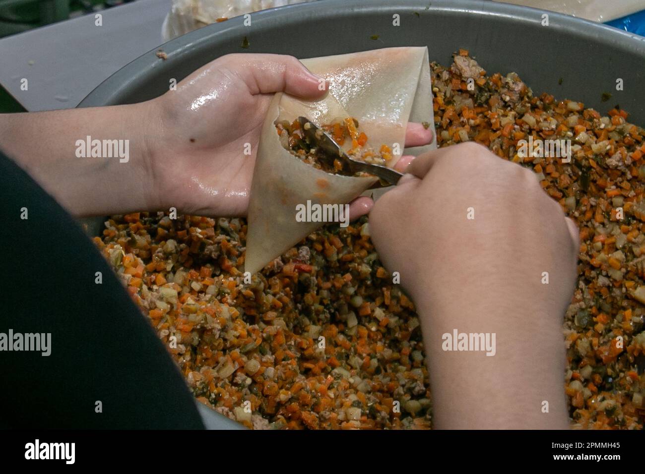 A worker produces cane bread at a Middle Eastern frozen food home