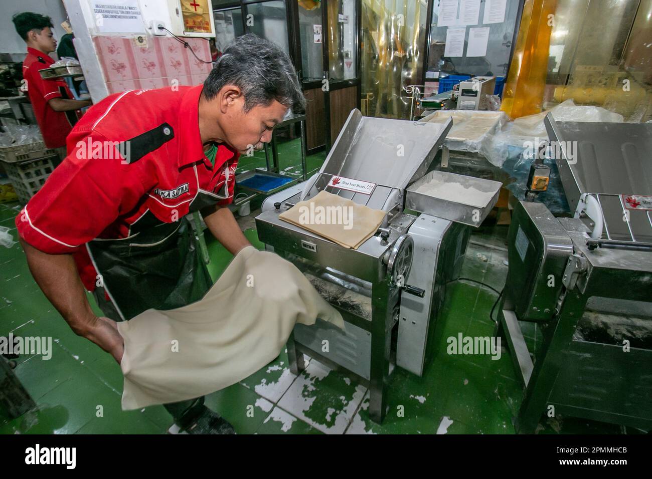 A worker produces cane bread at a Middle Eastern frozen food home