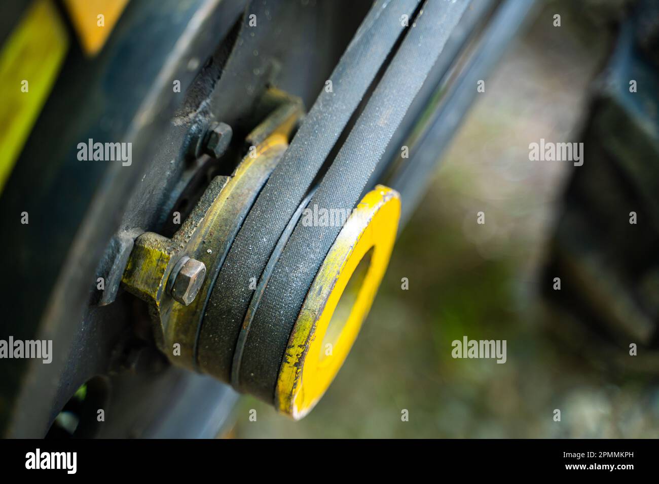 Walkbehind tractor pulley with two belts closeup. Tractor for