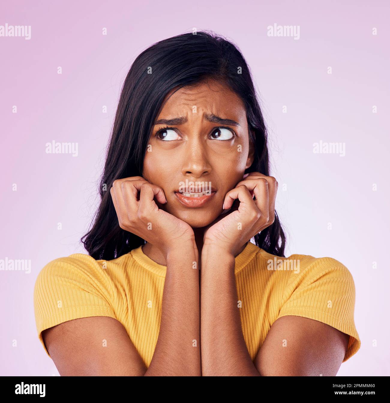 Scared, worry and face of Indian woman on pink background with