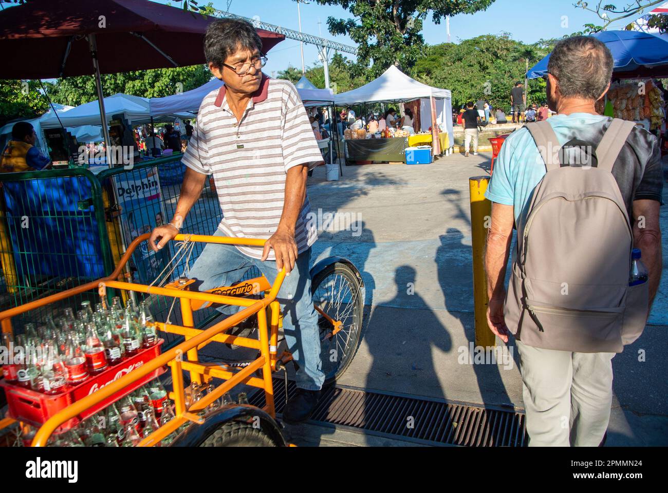 Cancun, Quintana Roo, Mexico, A mexican man carrying bottle of coca cola with a cargo in downtown of Cancun. Stock Photo