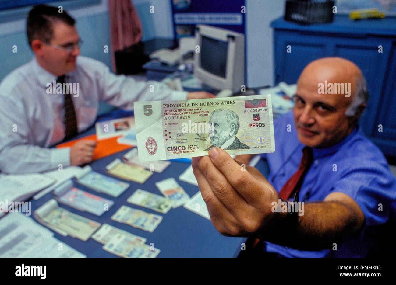 Argentina, Buenos Aires. Employee showing note. Stock Photo