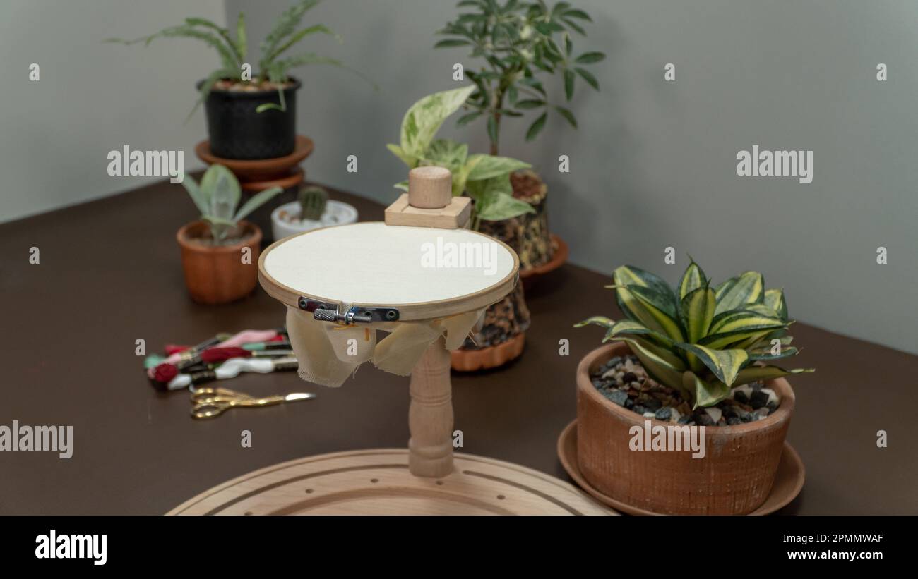 A set of needlework stand to embroidery project and a pot on the table. Stock Photo