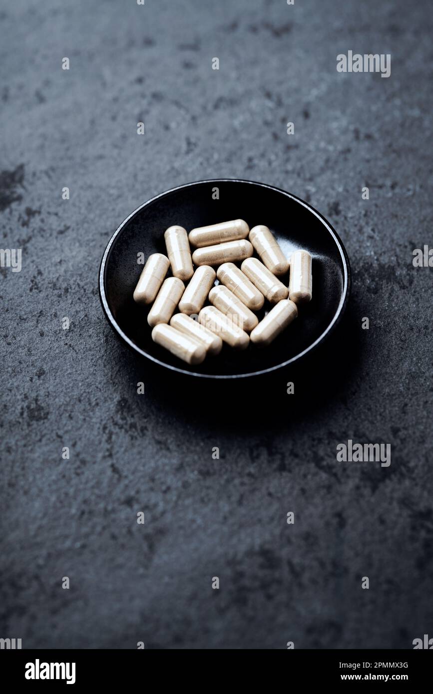 Ashwagandha (Withania somnifera) capsules. Dark stone background. Soft  focus. Copy space Stock Photo - Alamy