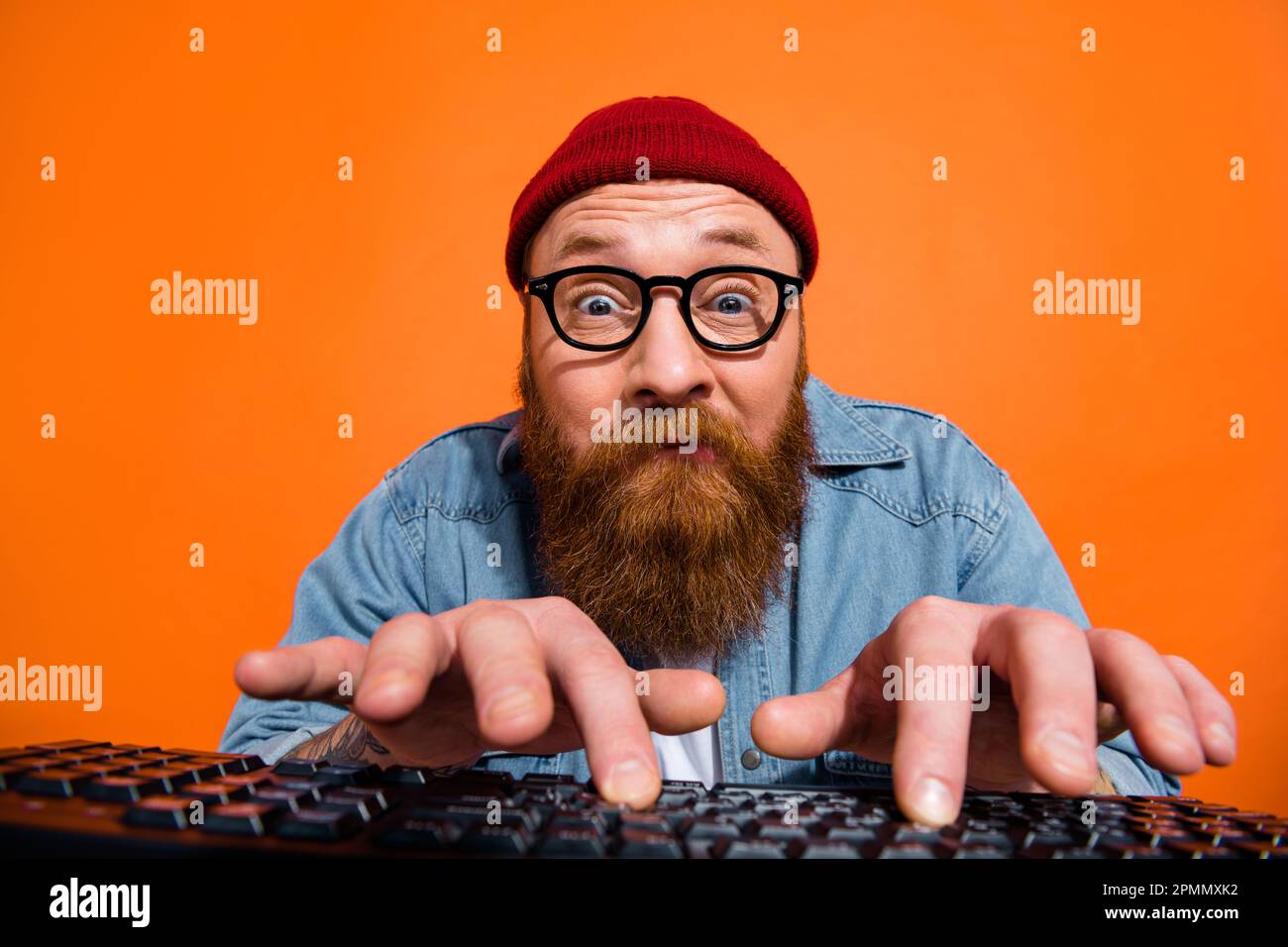 Photo of geek nerd guy dressed denim jacket eyeglasses communicating modern  gadget isolated orange color background Stock Photo - Alamy