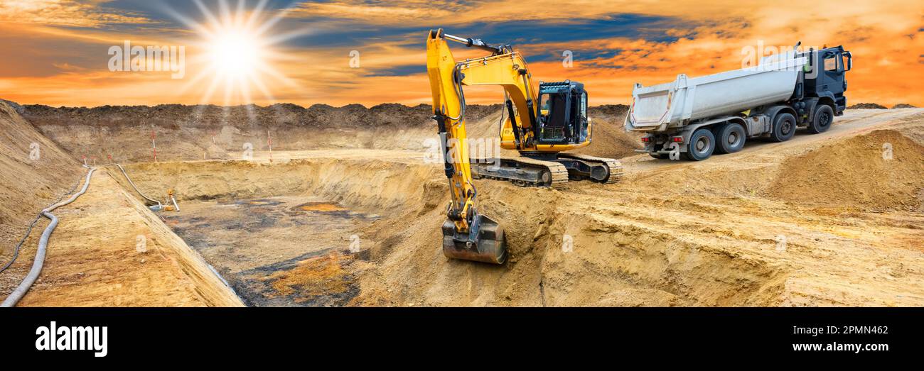 excavator ist digging and working at construction site Stock Photo