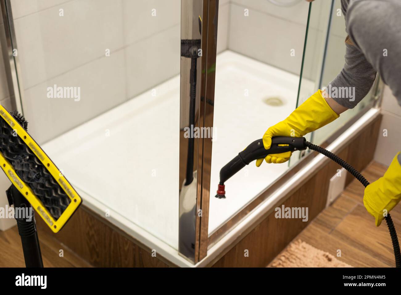wet cleaning the bathroom with a steam cleaner Stock Photo Alamy