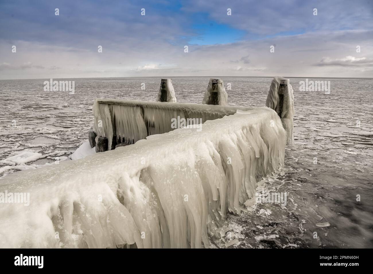 Den Oever, the Netherlands - February 10, 2021. Ice build-up on the piers of the Afsluitdijk in the IJsselmeer, Den Oever, Holland. Stock Photo