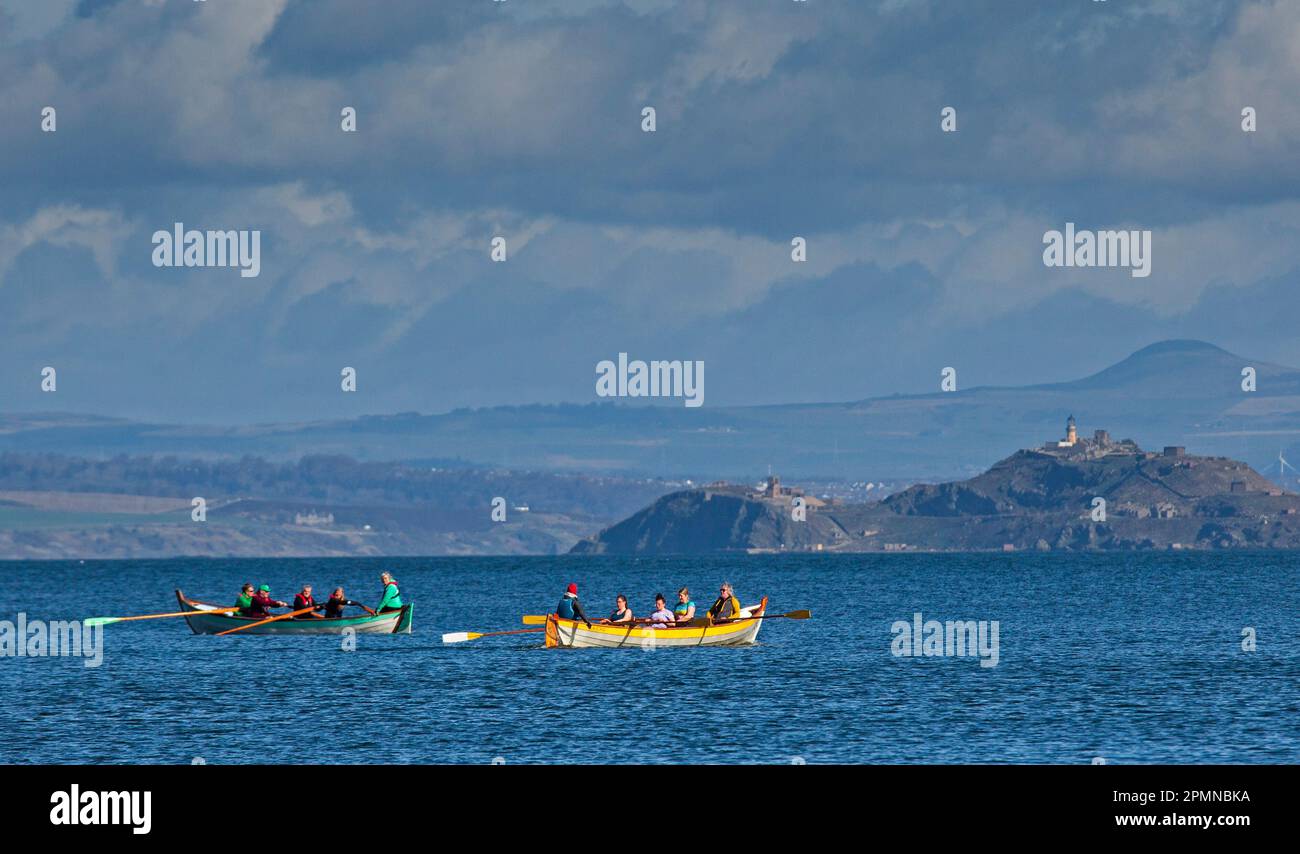 Portobello, Edinburgh, Scotland, UK. 14th April 2023. Morning exercise by the Firth of Forth. Pictured: Eastern Amateur Coastal Rowing Club rowing boat  crew pass Row Porty crew out on the Firth of Forth with Inchkeith island in background. Credit: Scottishcreative/alamy live news. Stock Photo