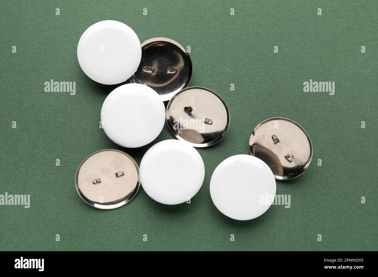 Blank white badges on green background Stock Photo - Alamy