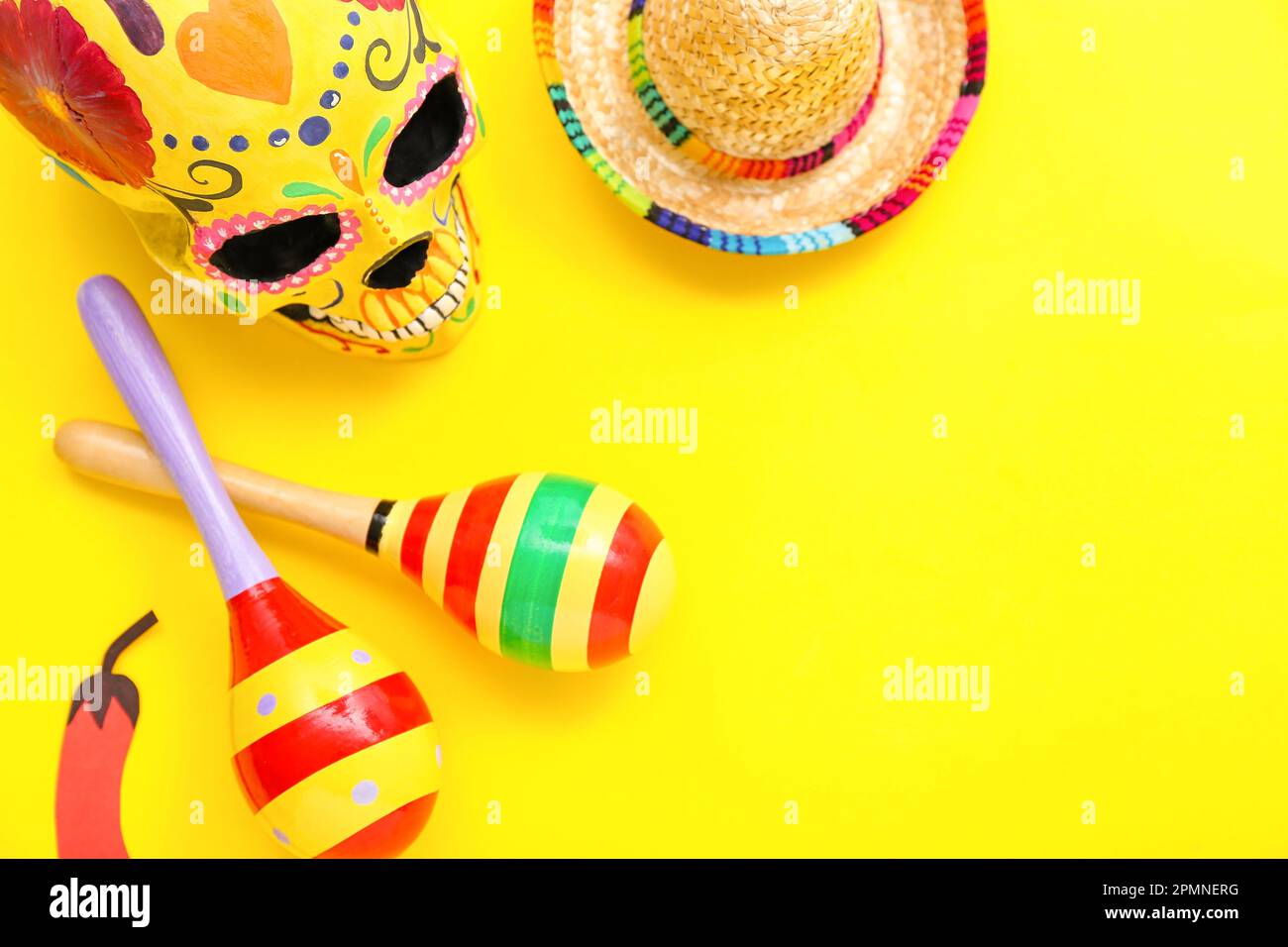 Mexican maracas, paper chili pepper, painted skull and sombrero hat on ...